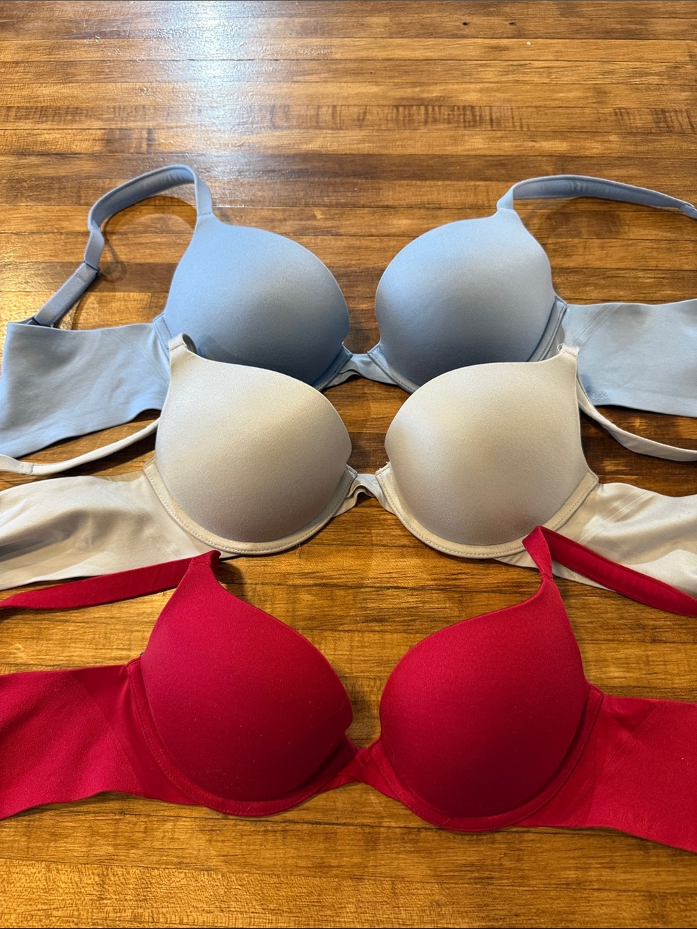 Three-pack SPANX Smooth T-Shirt Bras in Light Blue, Cream, and Red